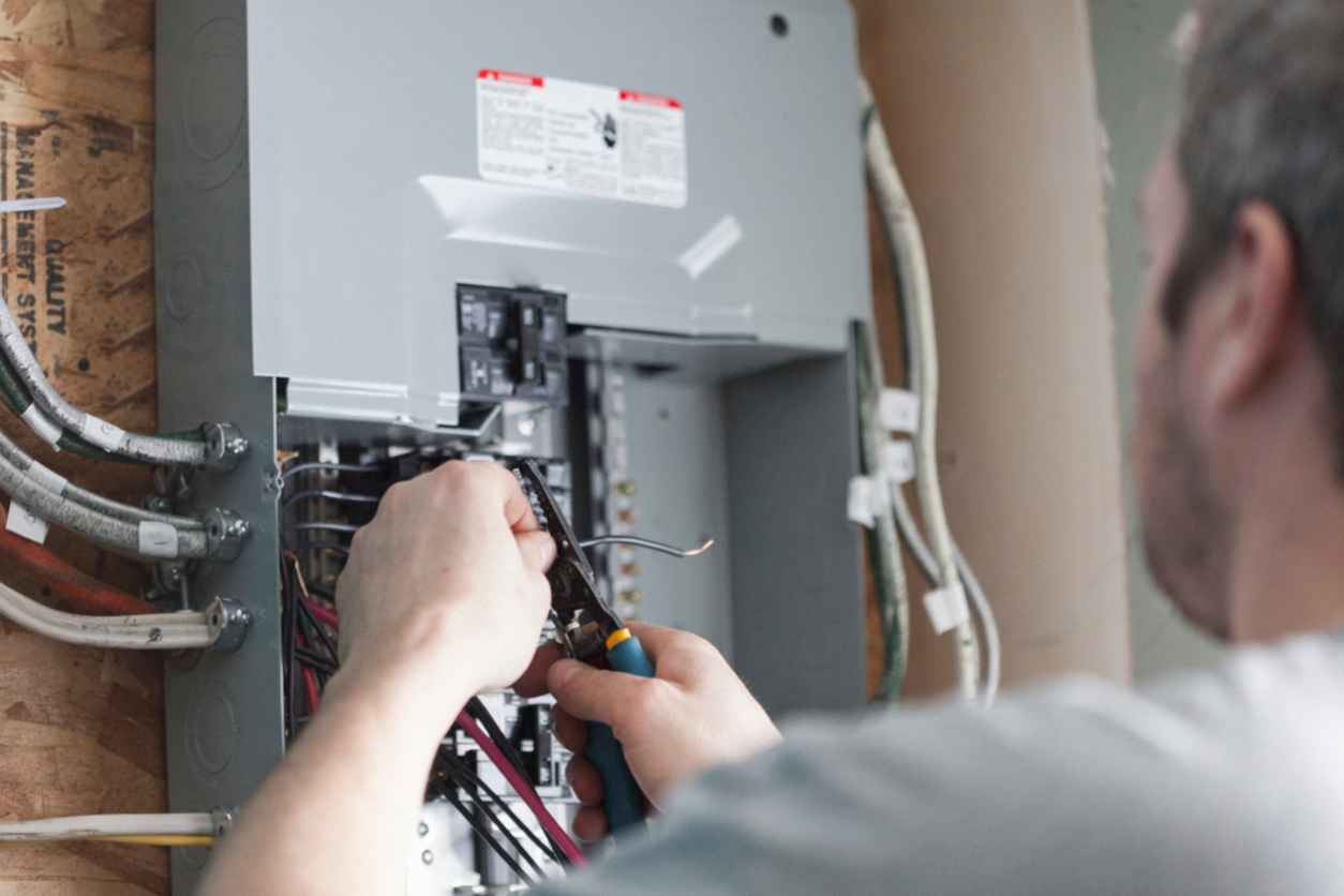 Electrician repairing a circuit breaker
