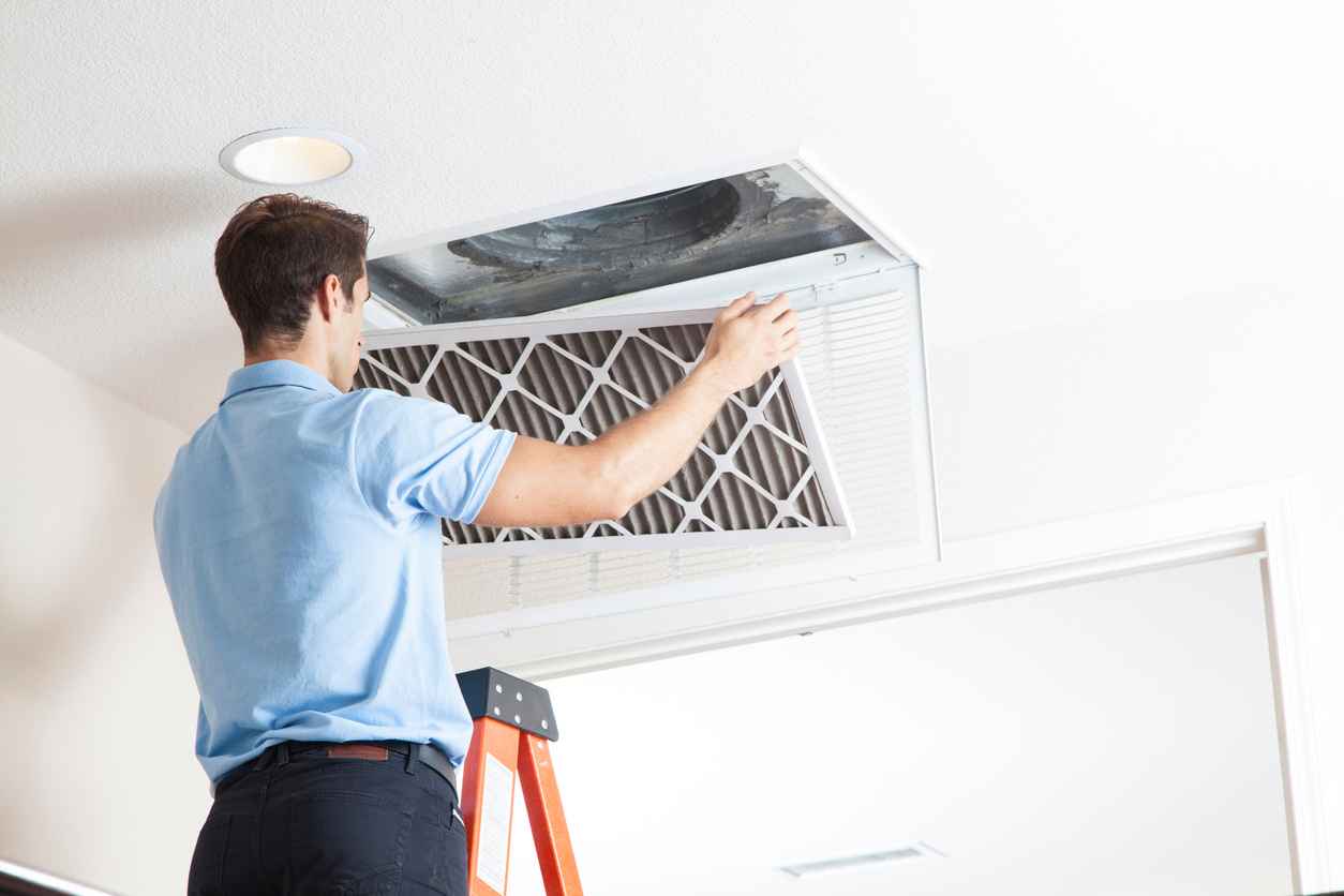 Man cleaning air ducts in home.