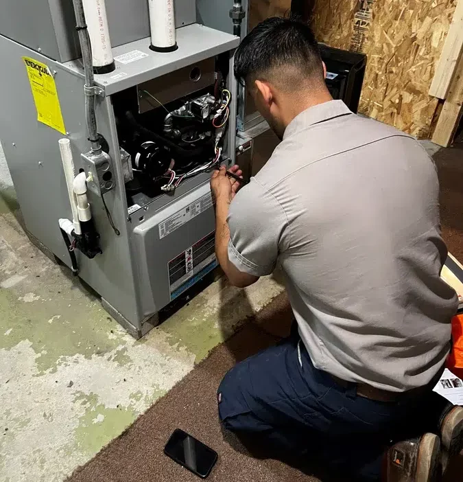 Technician repairing heating system.
