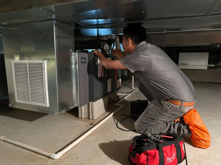 Technician servicing HVAC duct unit in Brookfield