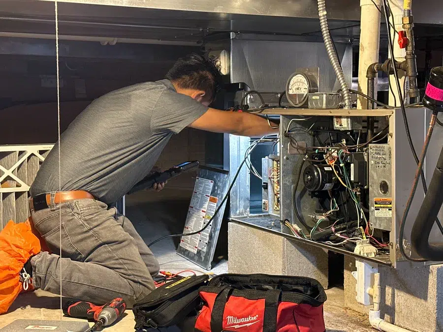 Technician servicing HVAC duct unit in Brookfield