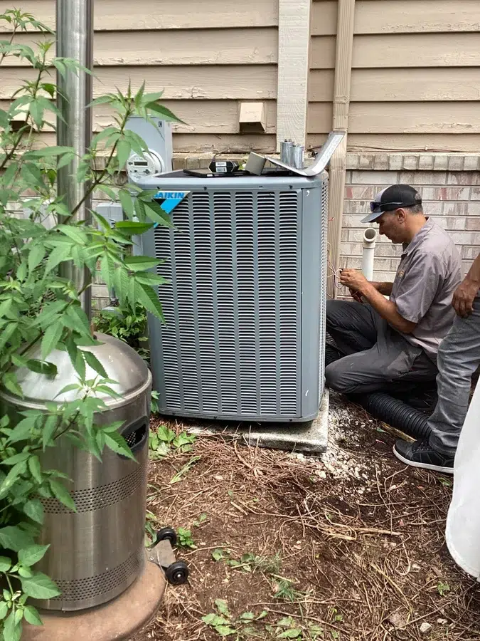 Technician servicing AC unit in Brookfield