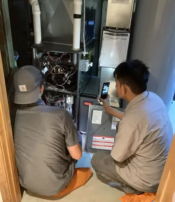 Technicians servicing HVAC unit in Brookfield