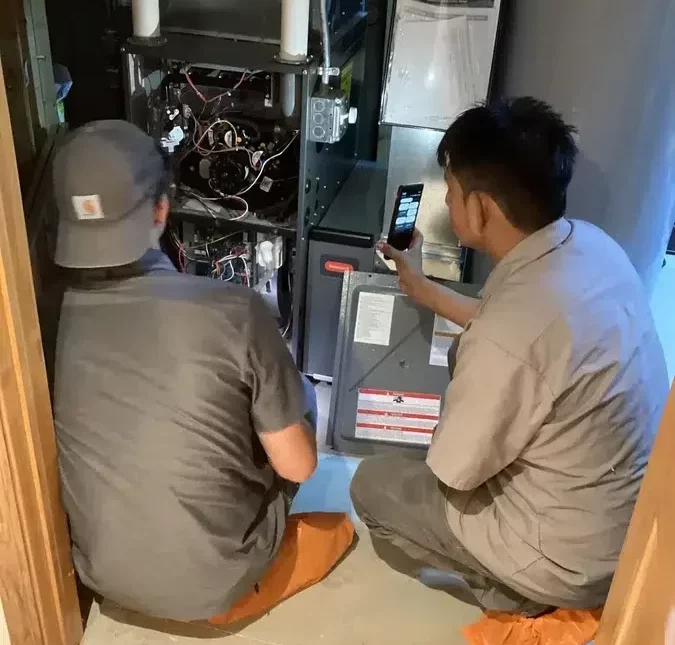 Technicians servicing HVAC unit in Brookfield