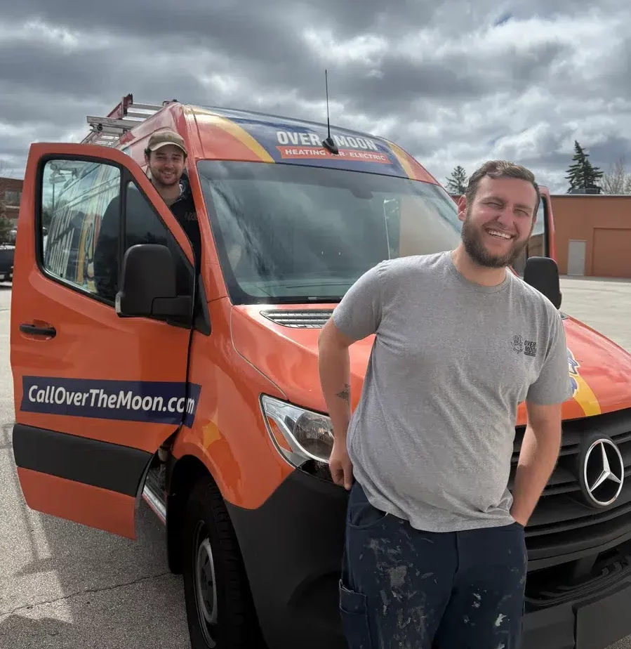 Over the Moon techs smiling in front of work van in Brookfield.
